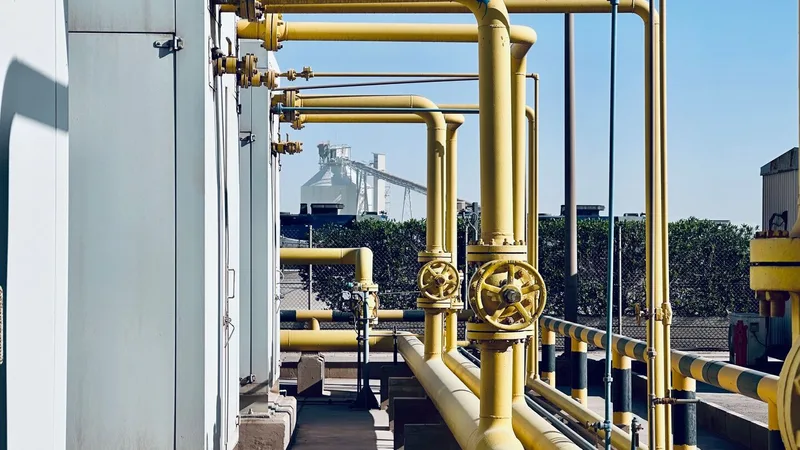 Yellow gas pipework and valves at an LPG bottling terminal